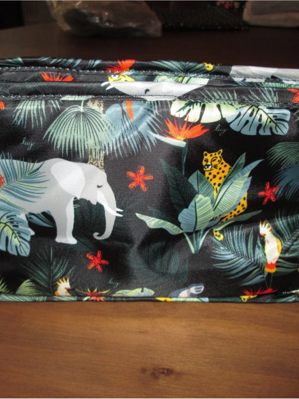 lug Tropical Animal Print Cosmetic Bag in Black with Green and Orange Accents